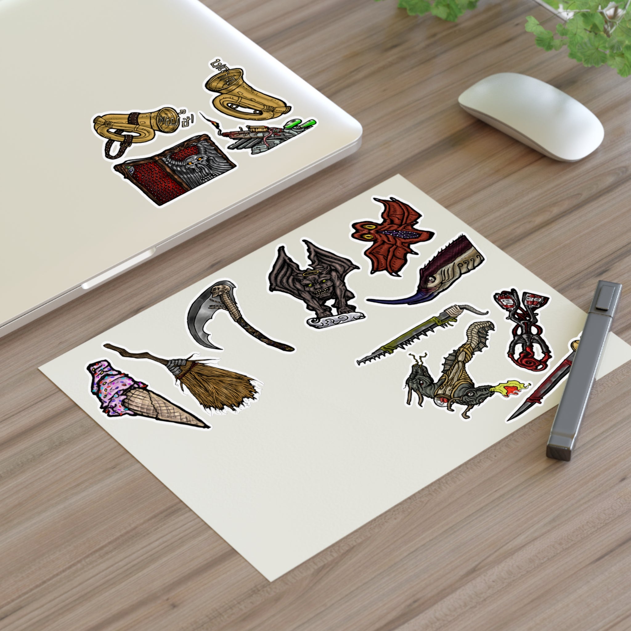 Freaky Features Sticker Sheet Set #4, transparent die-cut sheet with 14 hand-drawn weapons and creatures including ice cream cone, witch broom, skeletal scythe, bat-winged hellbeast, cursed tome and more
