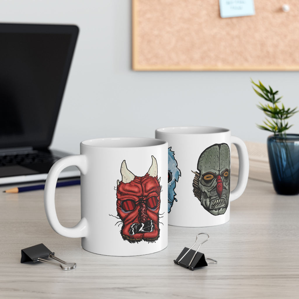 Freaky Features Iceman Devil Fishman mug showing three monster designs: blue icy skull with red goggles, red horned demon, and grotesque fishman head on white ceramic mug

