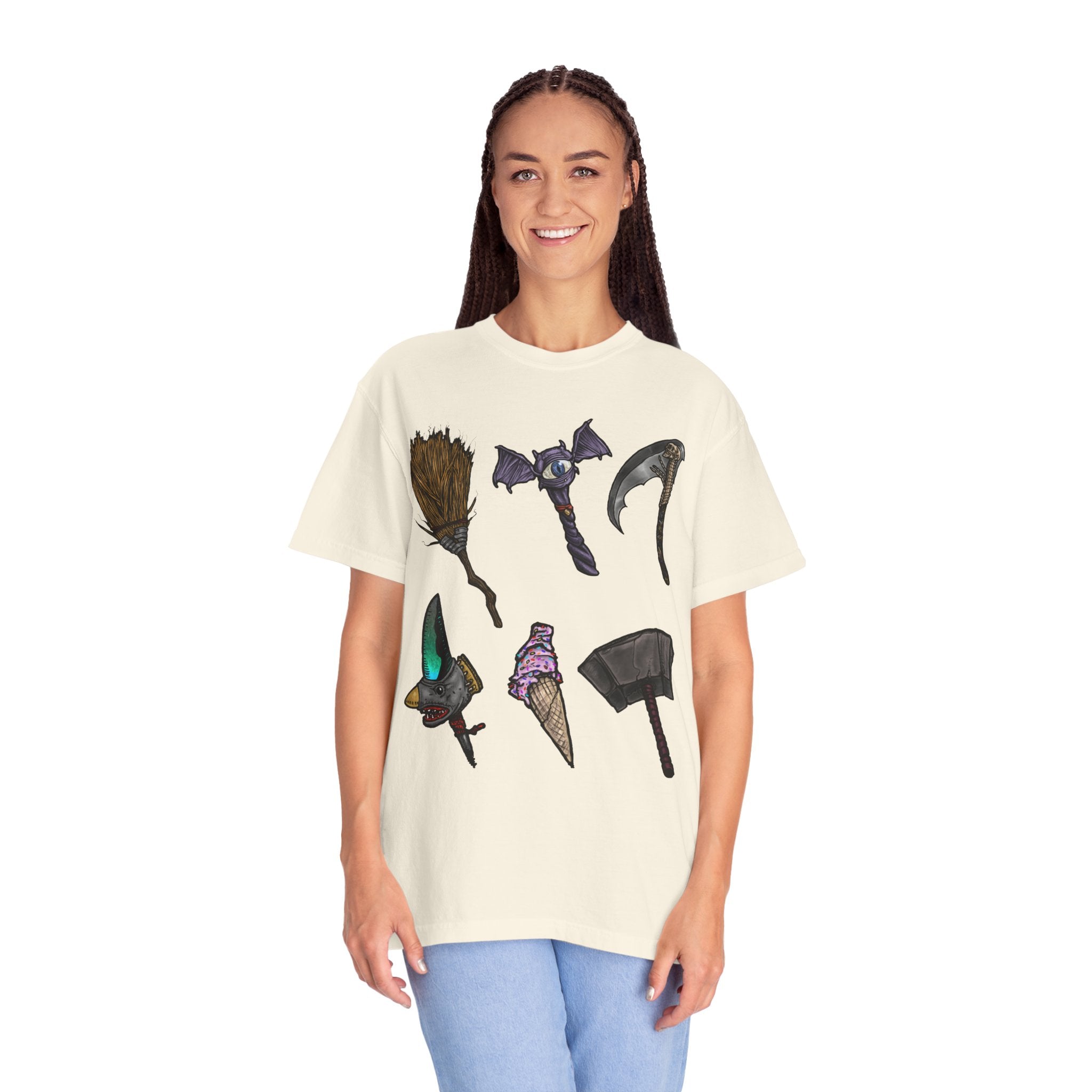 Hand-drawn Item Selection #1 t-shirt from Freaky Features showing a collection of monster weapons: broom, bat staff, skeletal scythe, shark dagger, ice cream cone and war hammer on dark gray tee
