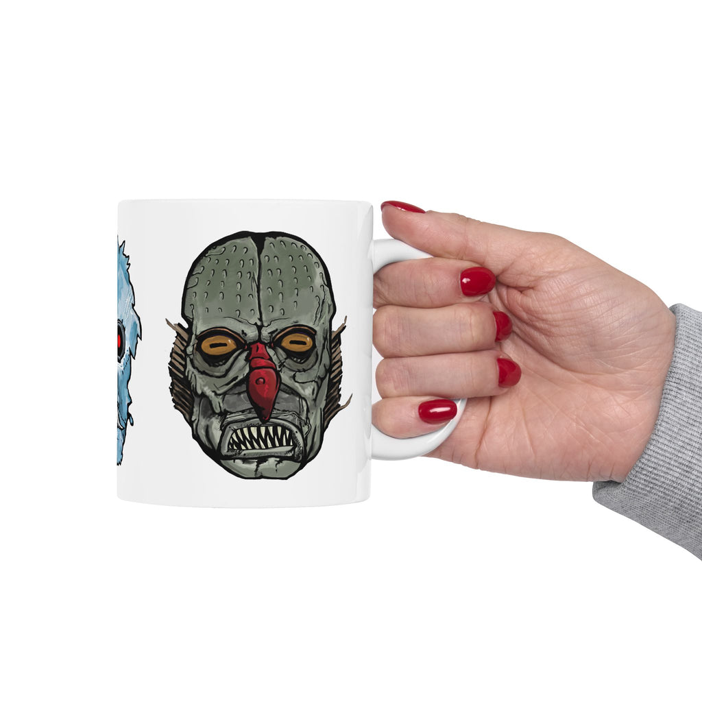 Freaky Features Iceman Devil Fishman mug showing three monster designs: blue icy skull with red goggles, red horned demon, and grotesque fishman head on white ceramic mug

