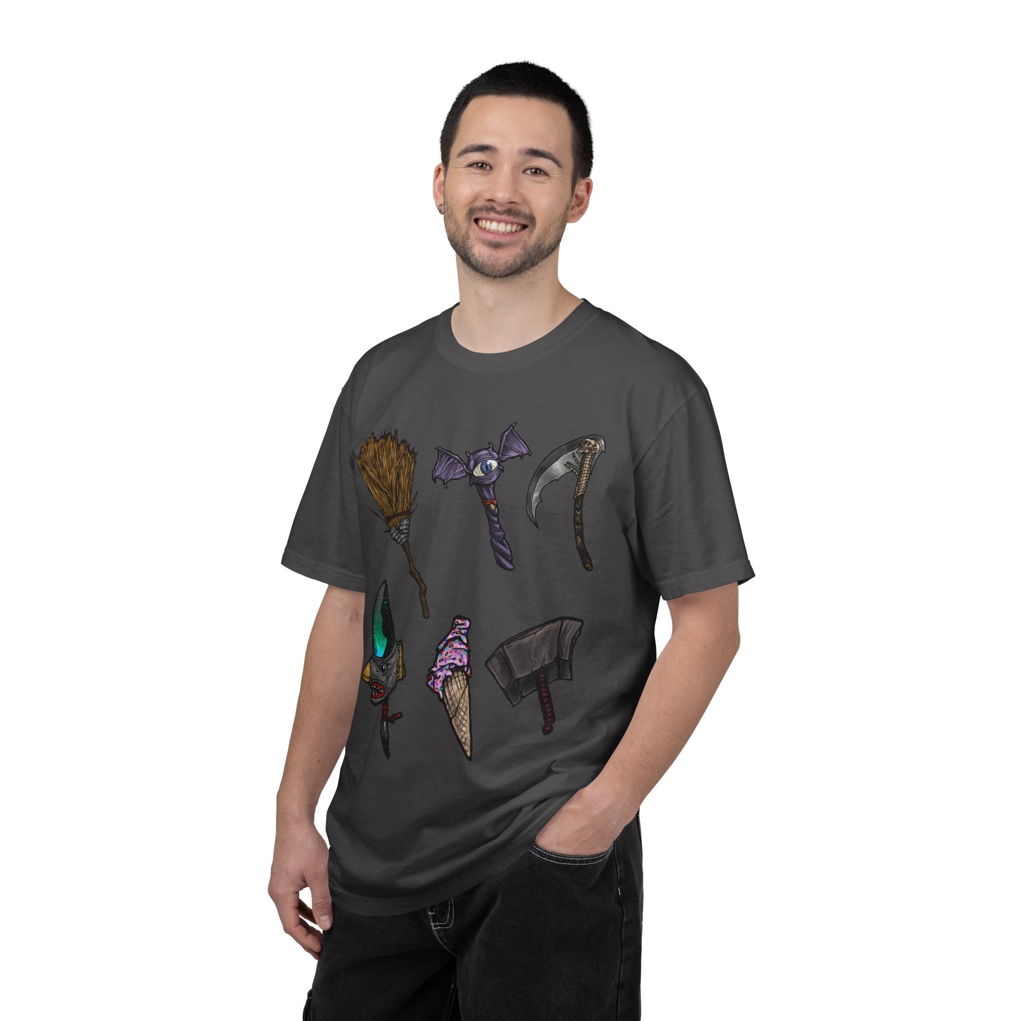 Hand-drawn Item Selection #1 t-shirt from Freaky Features showing a collection of monster weapons: broom, bat staff, skeletal scythe, shark dagger, ice cream cone and war hammer on dark gray tee
