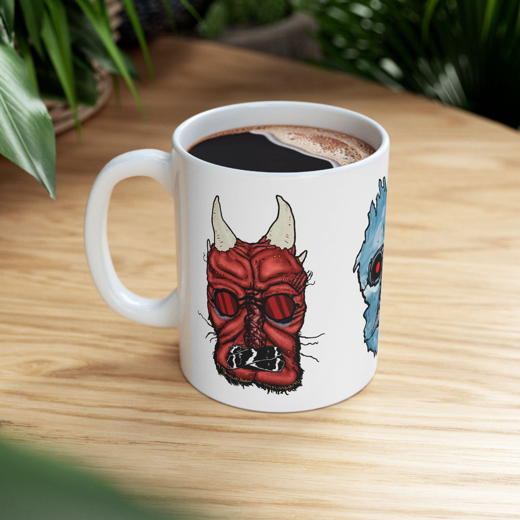 Freaky Features Iceman Devil Fishman mug showing three monster designs: blue icy skull with red goggles, red horned demon, and grotesque fishman head on white ceramic mug

