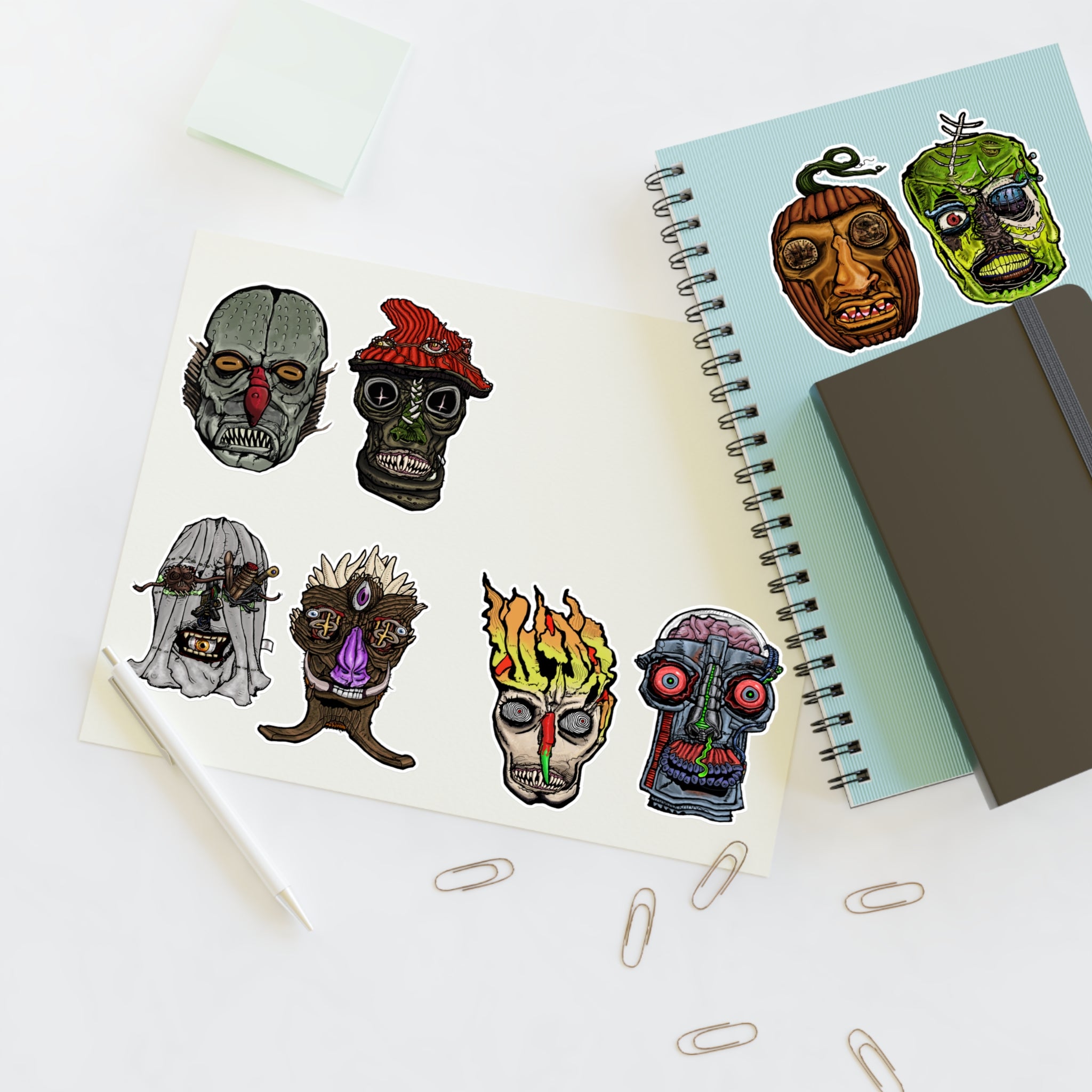 Freaky Features Sticker Sheet Set #2, transparent die-cut sheet with 8 hand-drawn monster heads including Fishman, Mushroom Boy, PumpkinJack, Radioactive Blob, Ghost, Flaming Skull, and Robo Bobo
