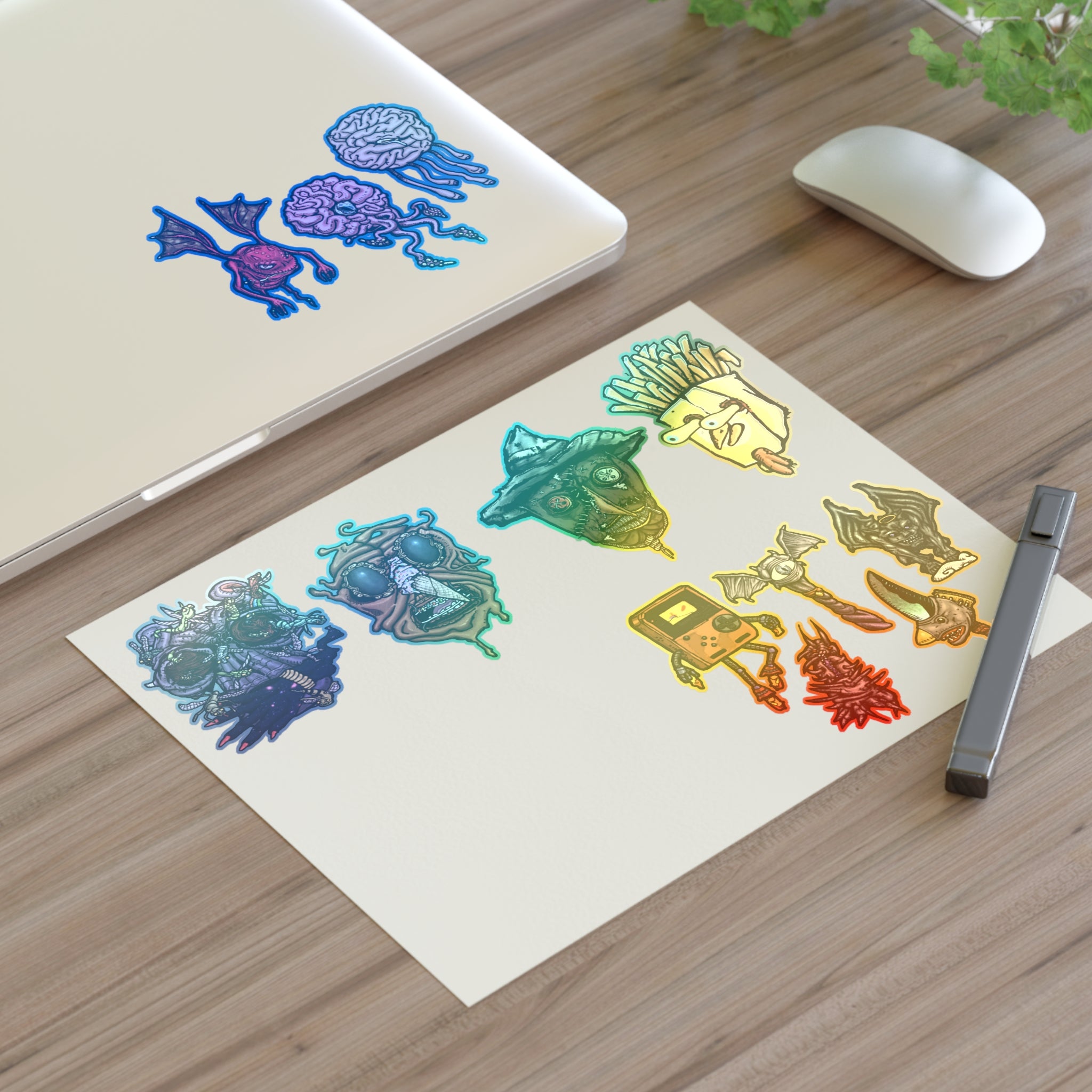 Freaky Features Sticker Sheet Set #3 , transparent die-cut sheet with 12 hand-drawn monsters and creatures including alien swarm, melting chocolate head, scarecrow, french fry box, walking Game Boy ( Gamerpal) , brains, and various weird weapons/creatures
