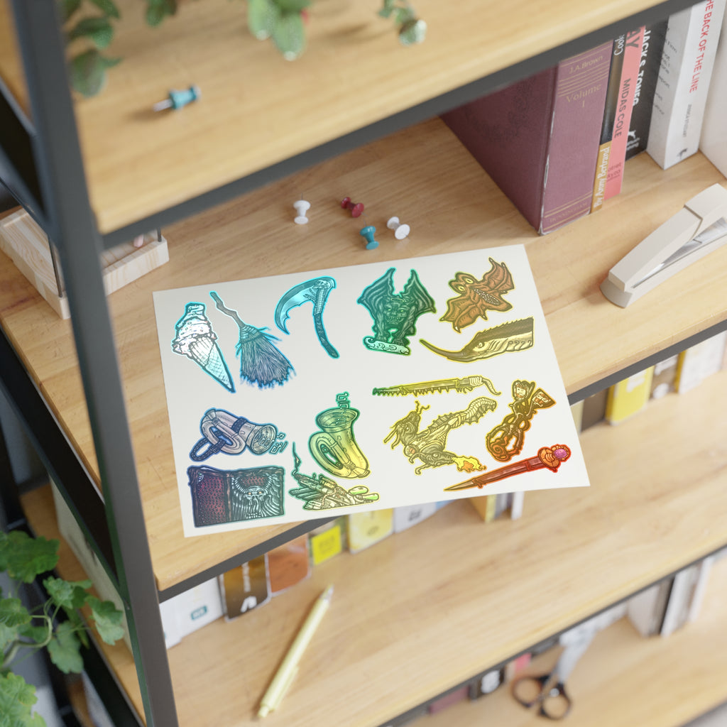 Freaky Features Sticker Sheet Set #4, transparent die-cut sheet with 14 hand-drawn weapons and creatures including ice cream cone, witch broom, skeletal scythe, bat-winged hellbeast, cursed tome and more

