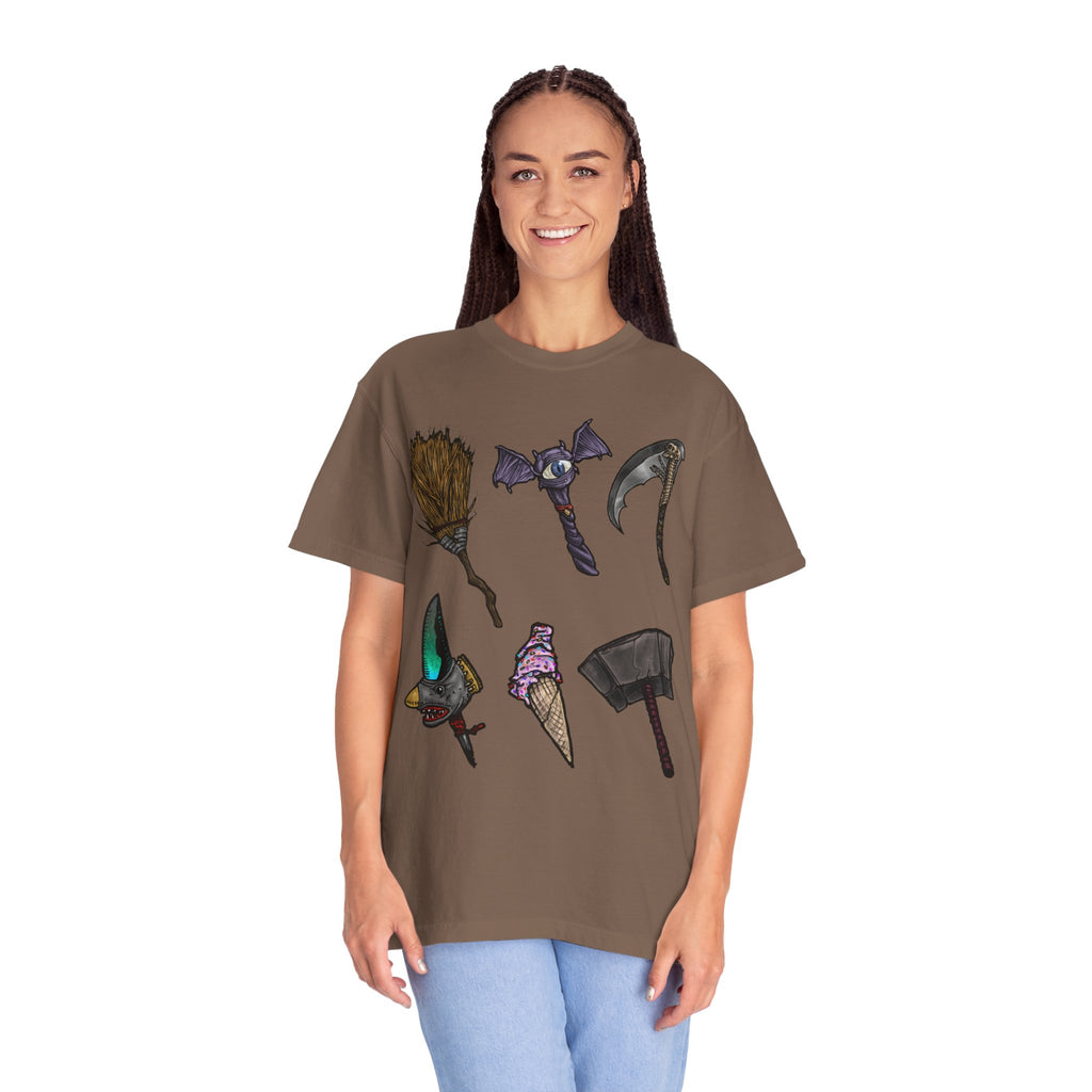 Hand-drawn Item Selection #1 t-shirt from Freaky Features showing a collection of monster weapons: broom, bat staff, skeletal scythe, shark dagger, ice cream cone and war hammer on dark gray tee
