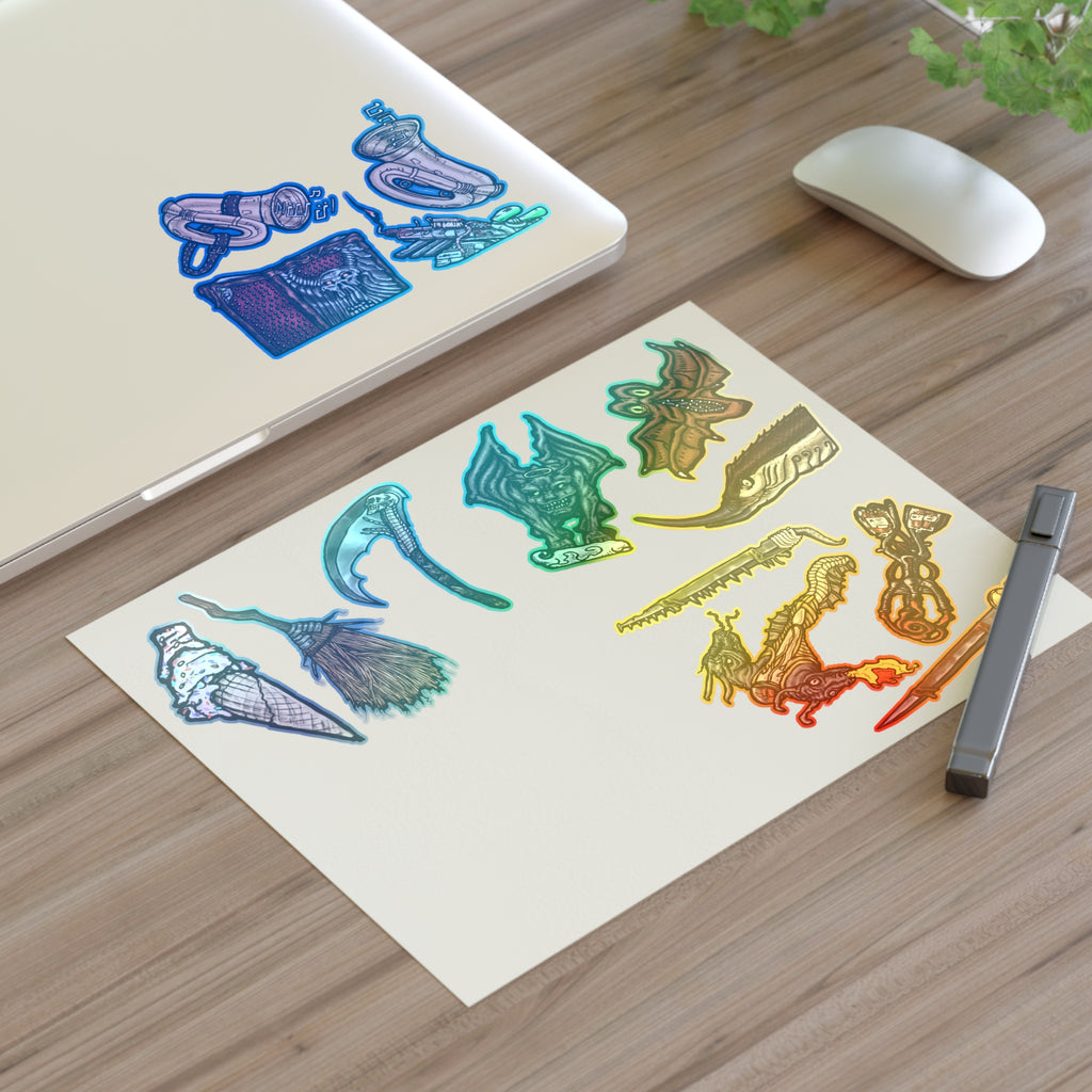 Freaky Features Sticker Sheet Set #4, transparent die-cut sheet with 14 hand-drawn weapons and creatures including ice cream cone, witch broom, skeletal scythe, bat-winged hellbeast, cursed tome and more
