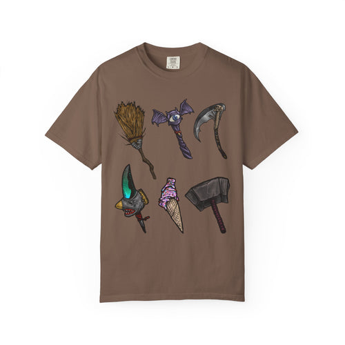Hand-drawn Item Selection #1 t-shirt from Freaky Features showing a collection of monster weapons: broom, bat staff, skeletal scythe, shark dagger, ice cream cone and war hammer on dark gray tee
