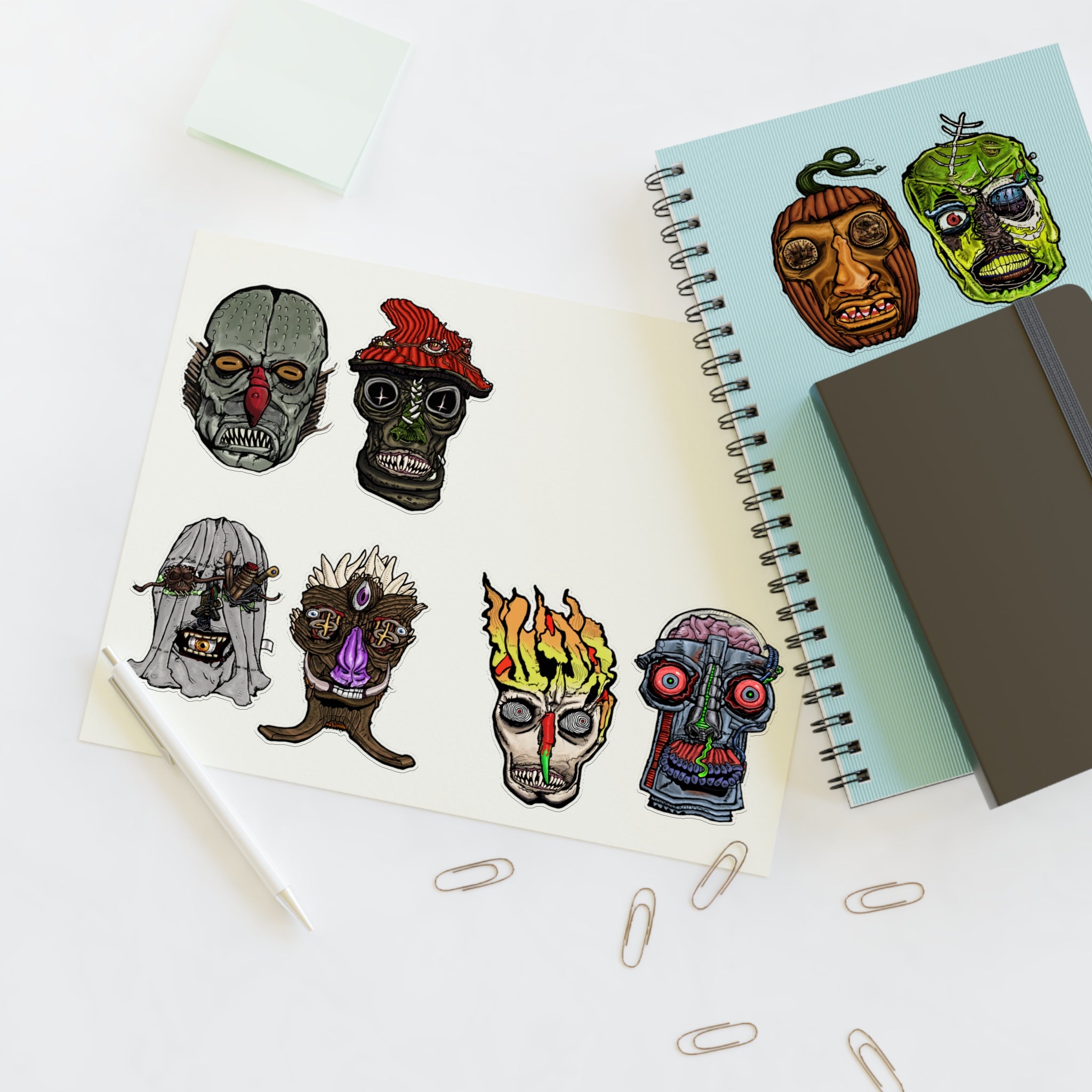 Freaky Features Sticker Sheet Set #2, transparent die-cut sheet with 8 hand-drawn monster heads including Fishman, Mushroom Boy, PumpkinJack, Radioactive Blob, Ghost, Flaming Skull, and Robo Bobo

